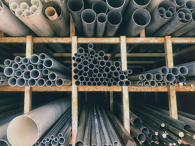 Steel and PVC pipes in a commercial plumbing supply warehouse