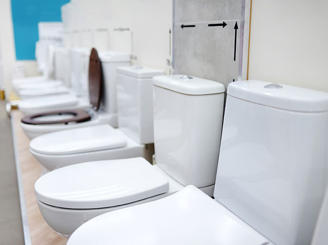 Toilets lined up in a commercial plumbing supplier